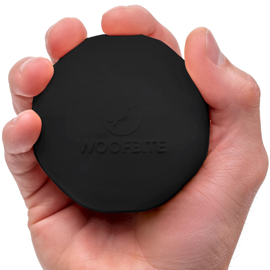 WoofBite rubber fetch ball showing thick wall construction and grip texture